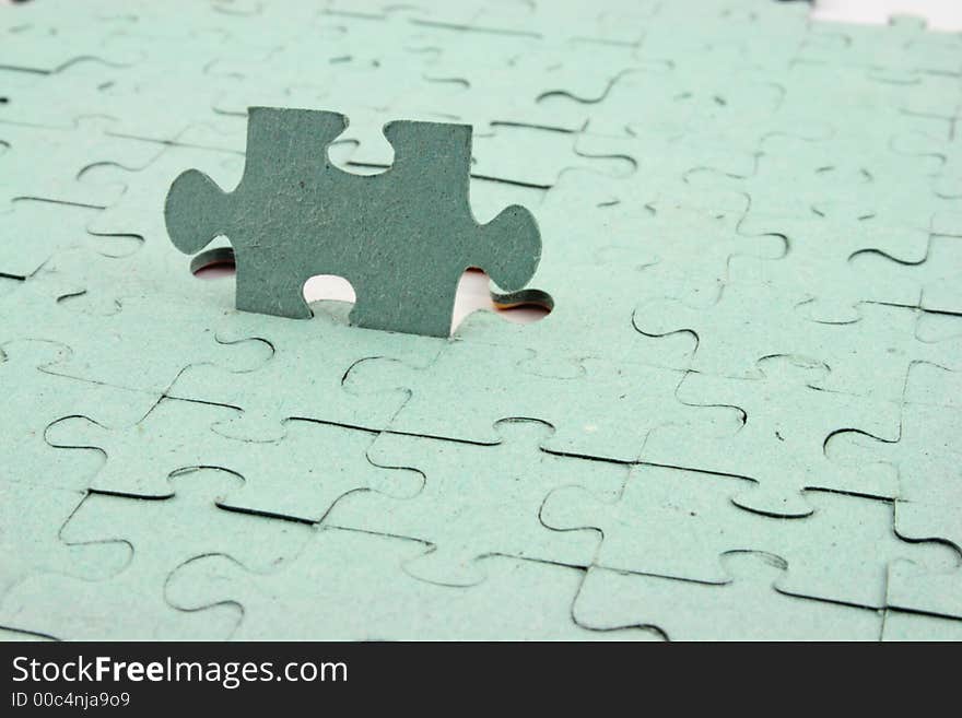 Close up of a Jigsaw with one element standing up. Close up of a Jigsaw with one element standing up