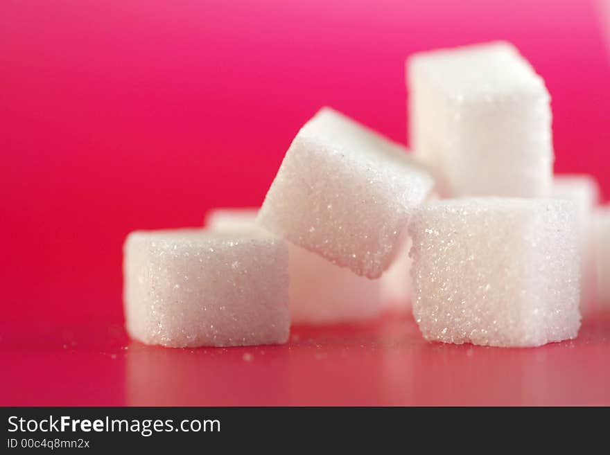 Sugarcubes infront of a pink background