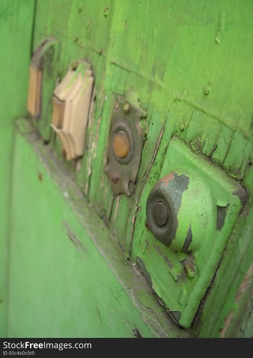 Various shapped painted green doorbells.