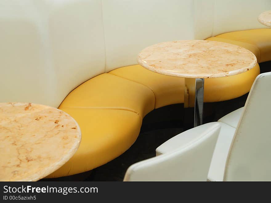 A couch and tables in a cafe. A couch and tables in a cafe