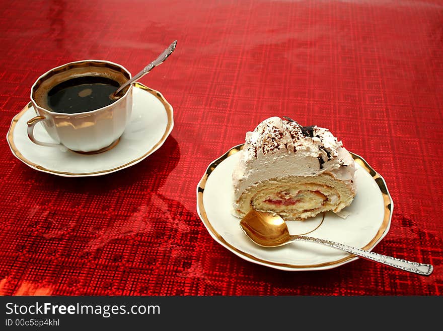 Cup of coffee with the spoon and a slice of a pie on a red backg