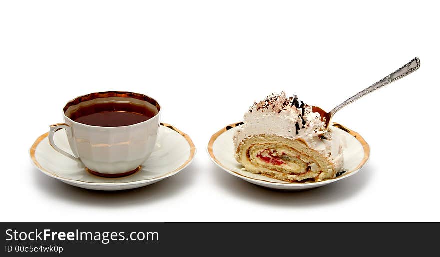 Cup of tea with the spoon and slice of pie on white