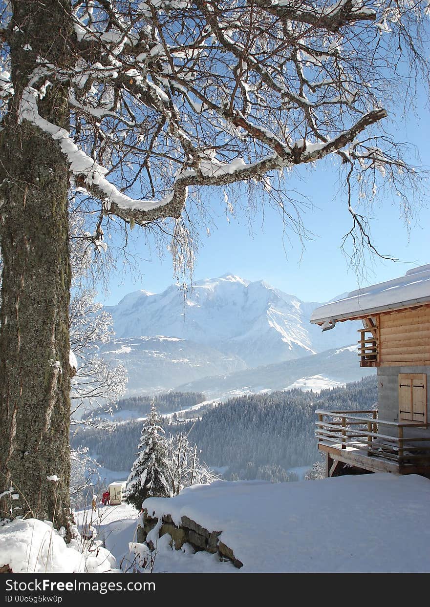 Mountain seen of a snow-covered country cottage. Mountain seen of a snow-covered country cottage