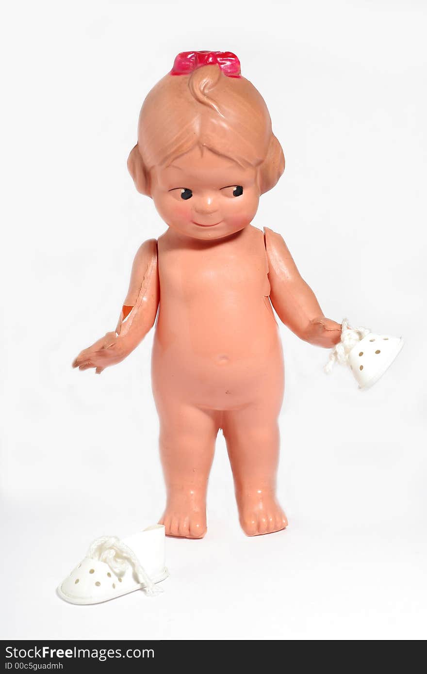 Old happy children doll with shoe