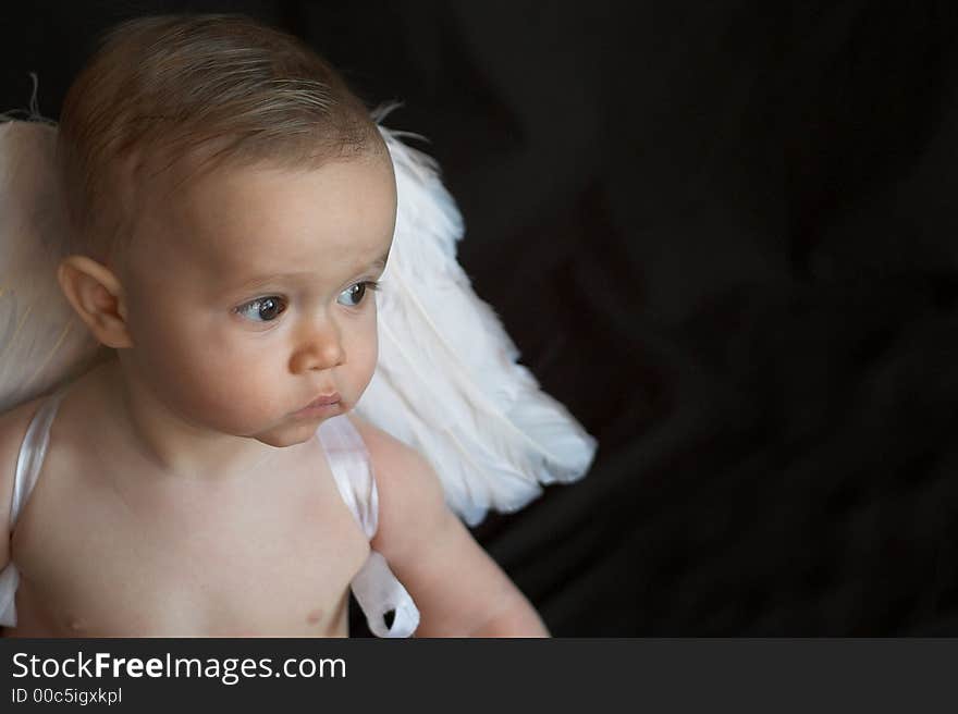 Image of baby wearing angel wings. Image of baby wearing angel wings