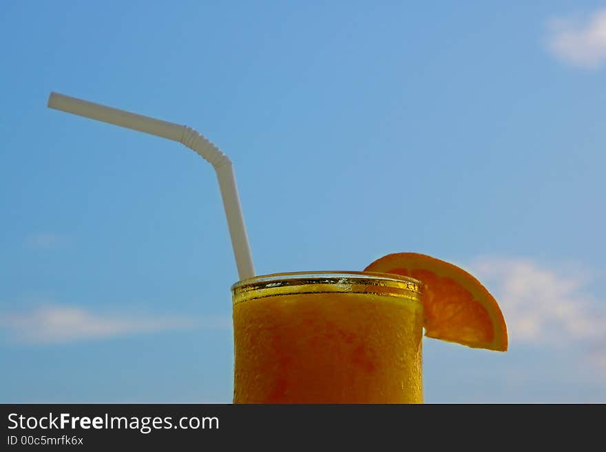 Glass of juice against blue sky