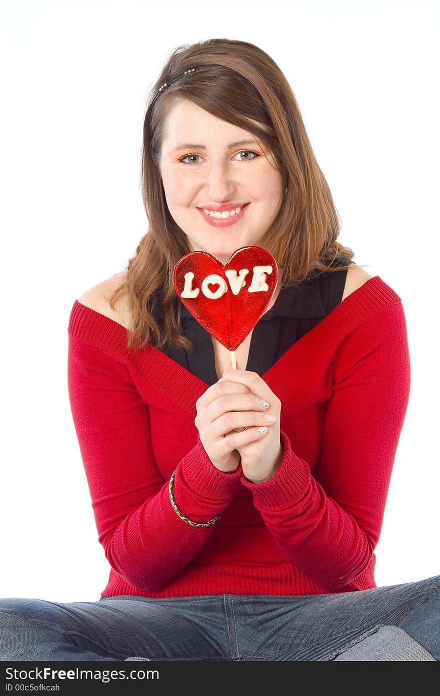 Girl holding a big red 'love' lollipop. Isolated on white. Girl holding a big red 'love' lollipop. Isolated on white.