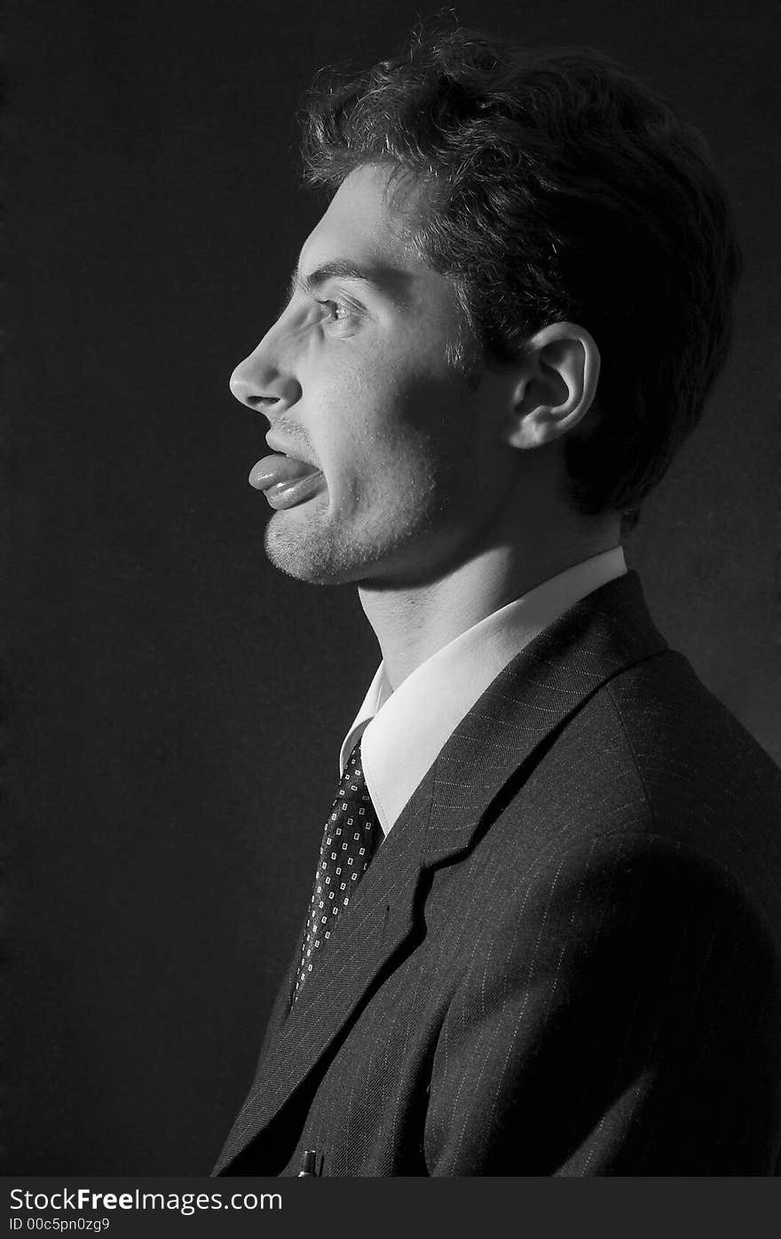 Portrait of discontent office worker. Half face. Black&white. Over black background