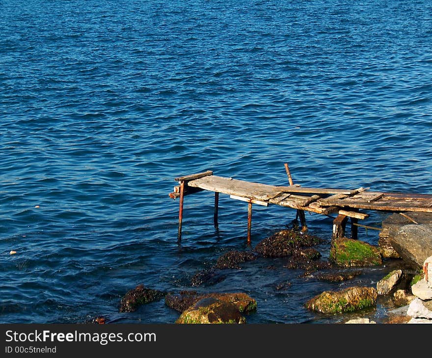 Tiny, mini, sea wharf, standing lonely in the sea of blue