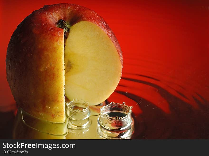 Red apple and water with ripples. Red apple and water with ripples