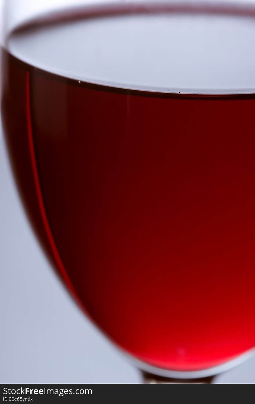 The close up of the red wine glass