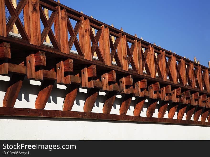 Sunny timber construction on a wall. Sunny timber construction on a wall