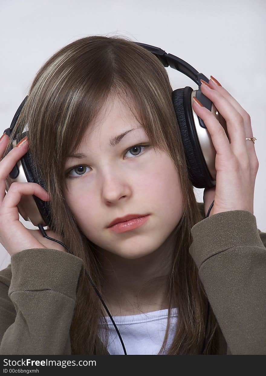 Portrait of the young beautiful glamour woman with headphones. Portrait of the young beautiful glamour woman with headphones