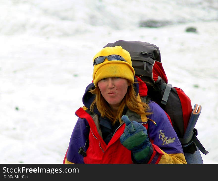 Woman mountaineer makes expressive gesture. Woman mountaineer makes expressive gesture