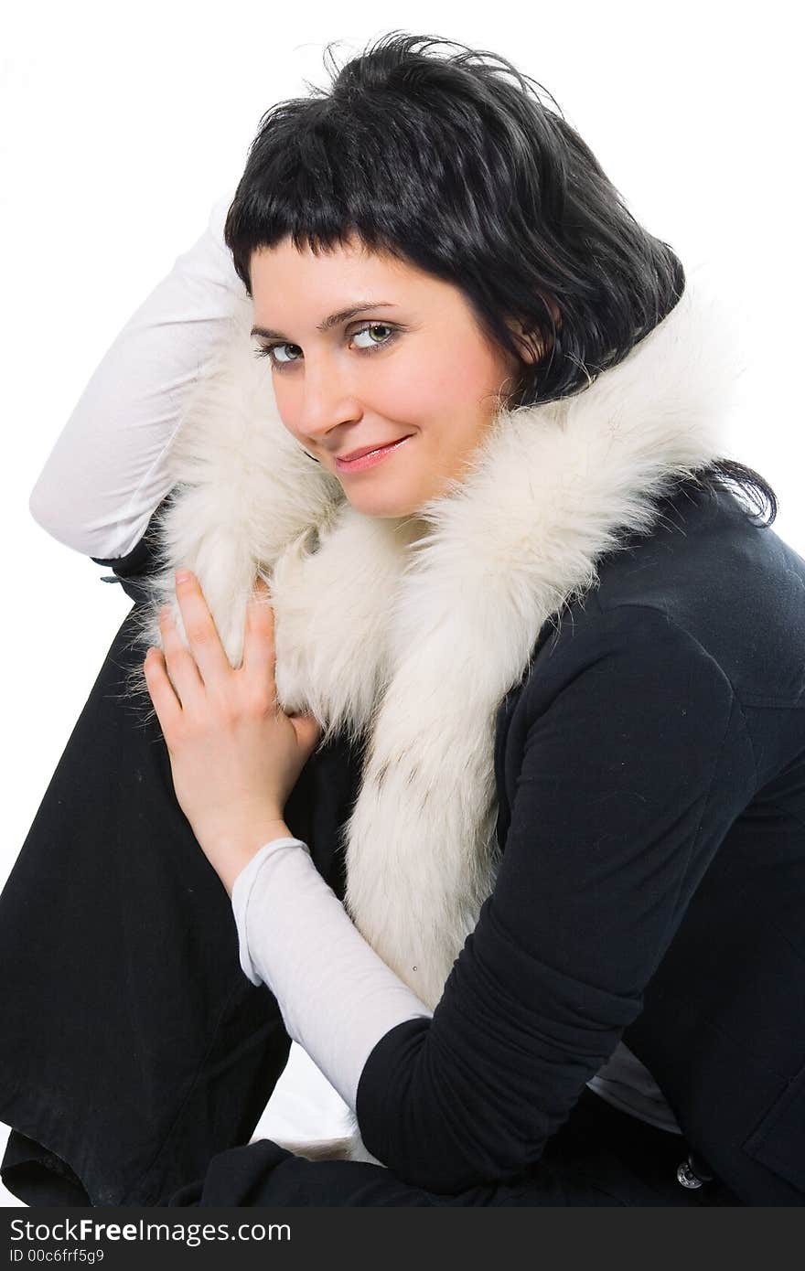 Beauty smiling brunette woman in fur on white background