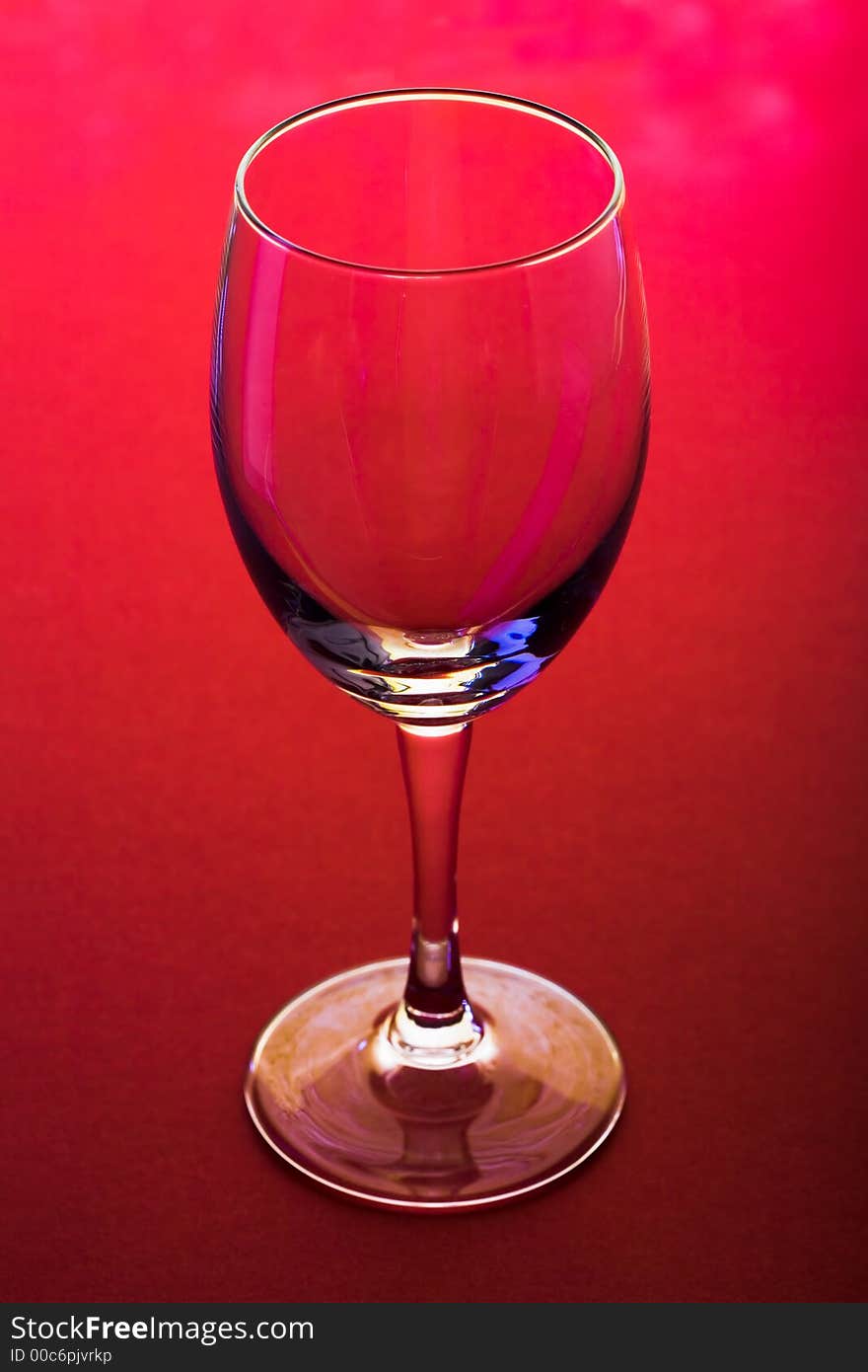 The close up of the wine glass on red