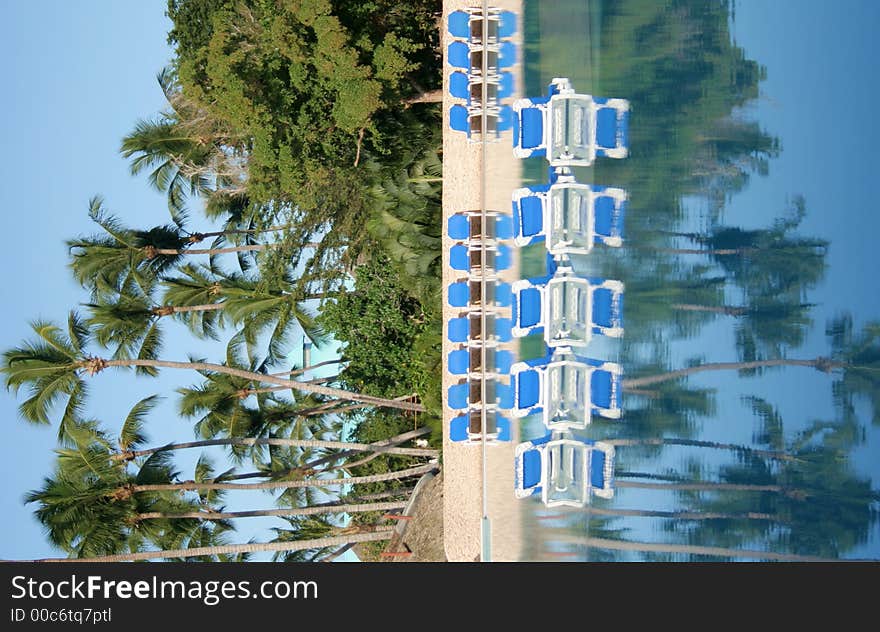 Chairs near a pool in the tropics. Chairs near a pool in the tropics