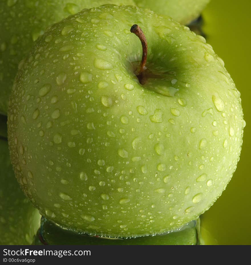 Green apple, water and mirror surface. Green apple, water and mirror surface