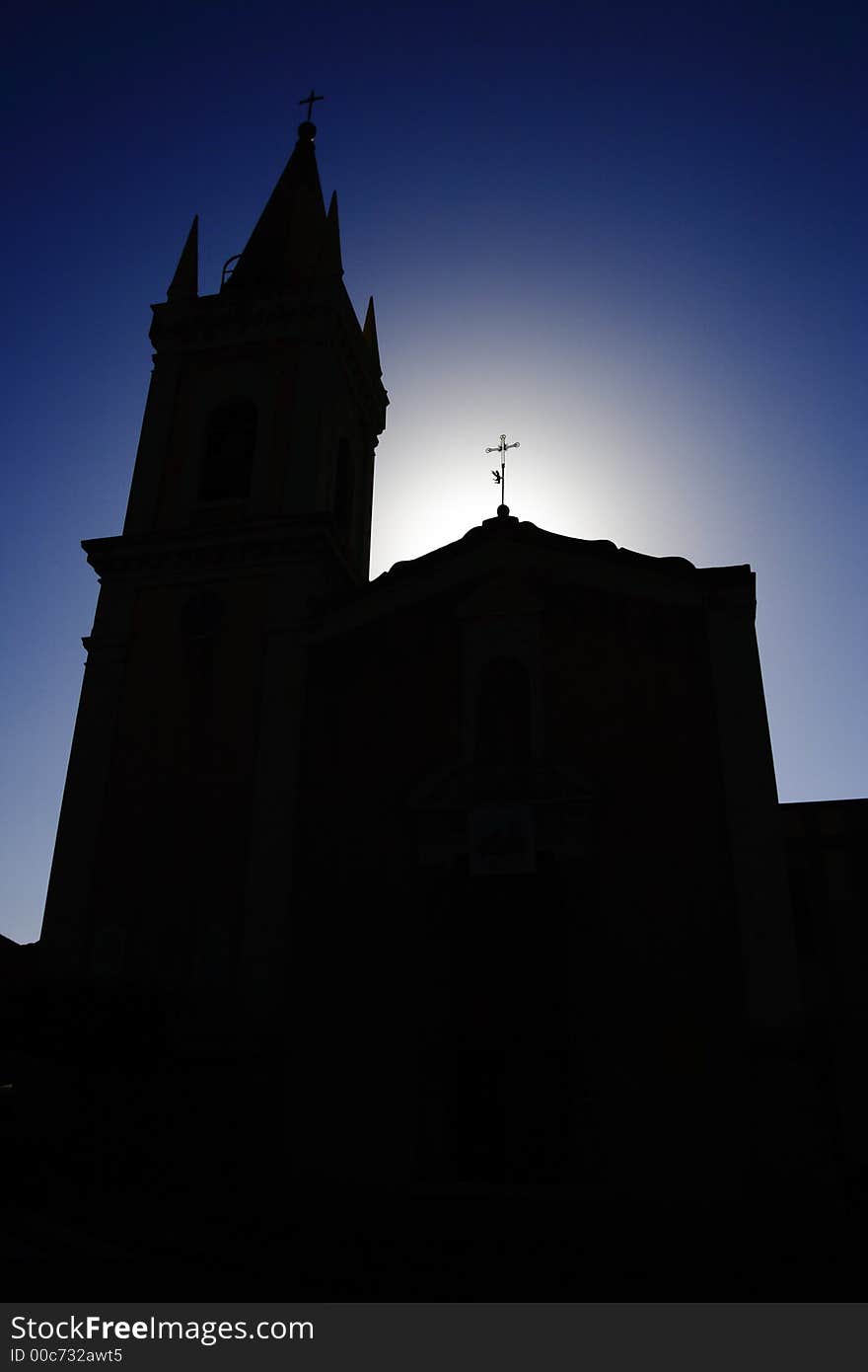 Photo of a church illuminated from behind. Photo of a church illuminated from behind.