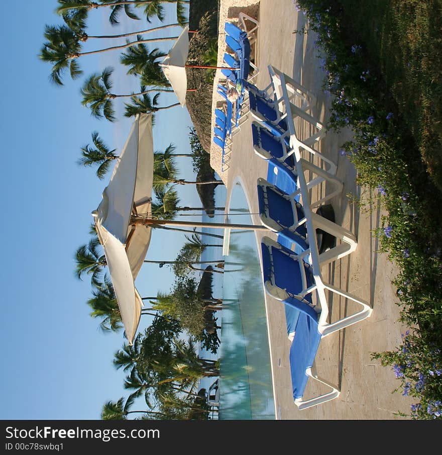 Chairs near a pool in the tropics. Chairs near a pool in the tropics