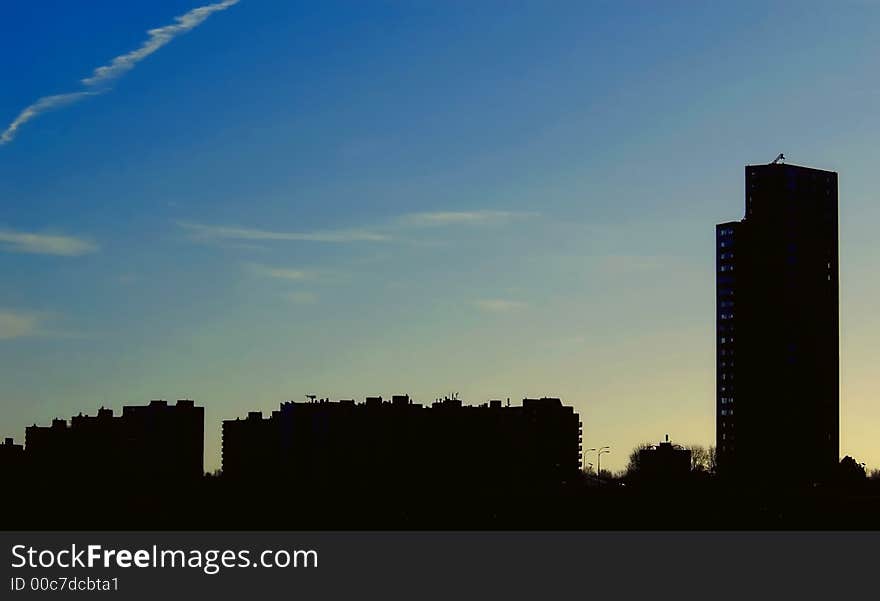 Skyline silhouette against blue sky with some clouds