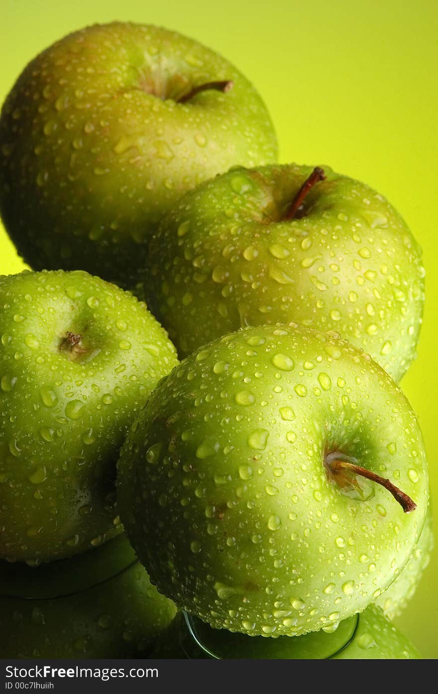 Green apple, water and mirror surface. Green apple, water and mirror surface