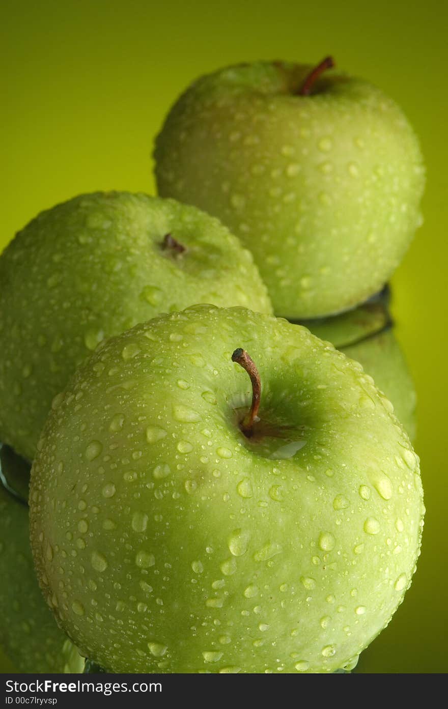 Green apple, water and mirror surface. Green apple, water and mirror surface