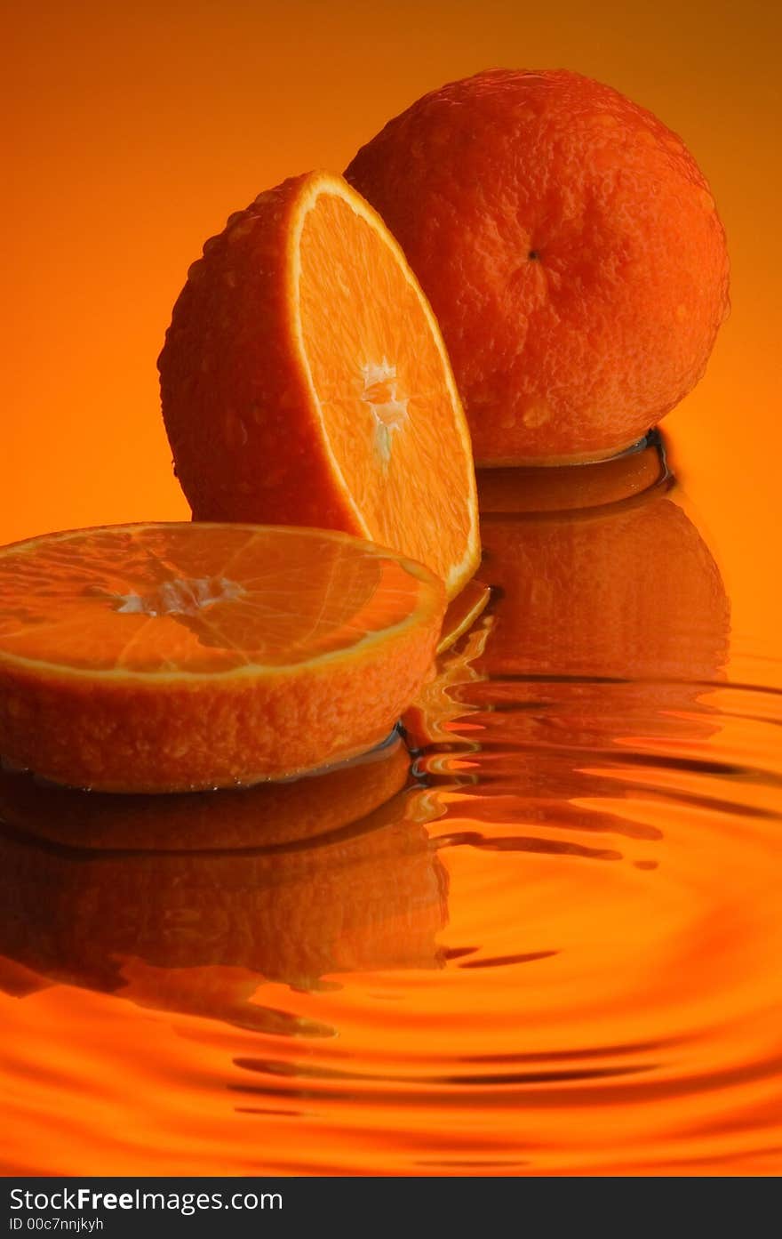 Orange, water and mirror surface. Orange, water and mirror surface