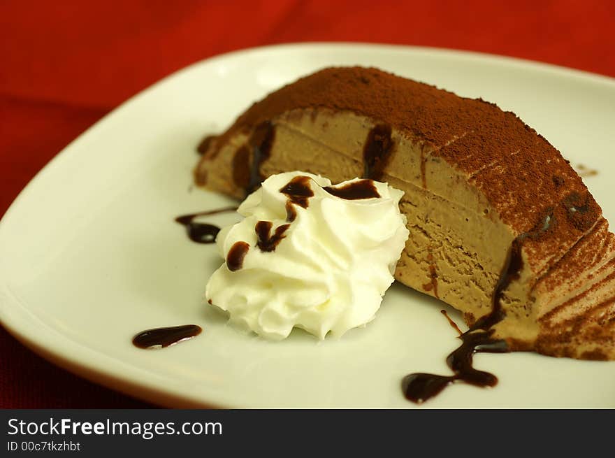 Chocolate semifreddo with cream on a plate