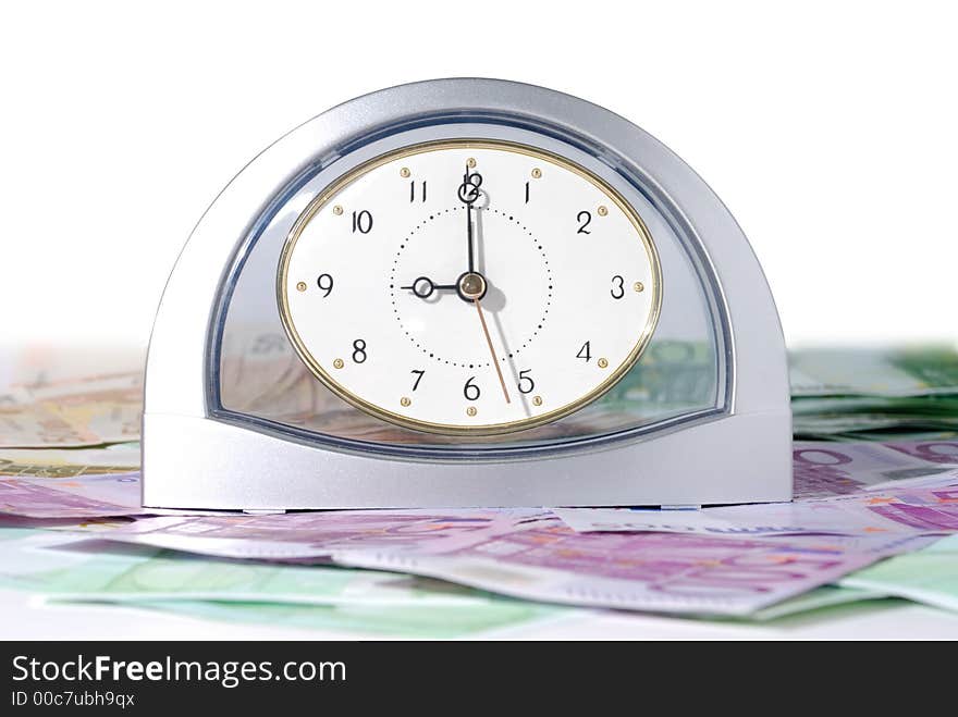 Chrome clock with euro bills over white background. Chrome clock with euro bills over white background