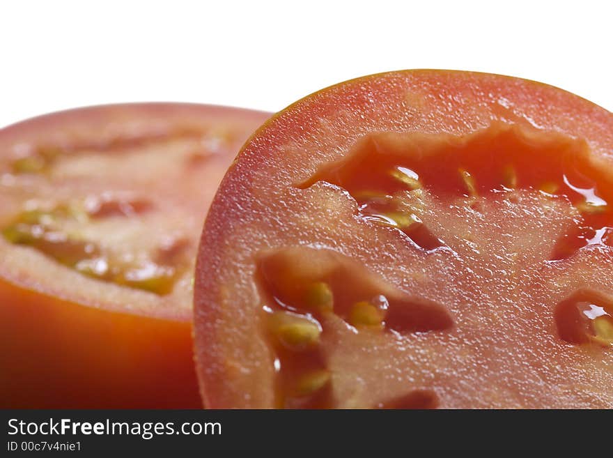 The cut tomato. Isolated. Close-up.