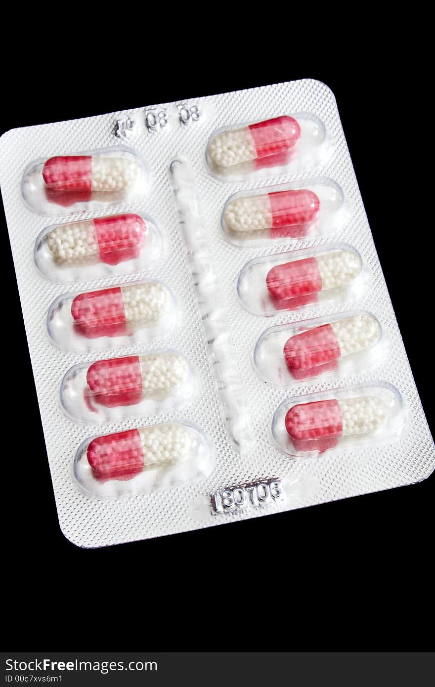 Package of pills isolated on black