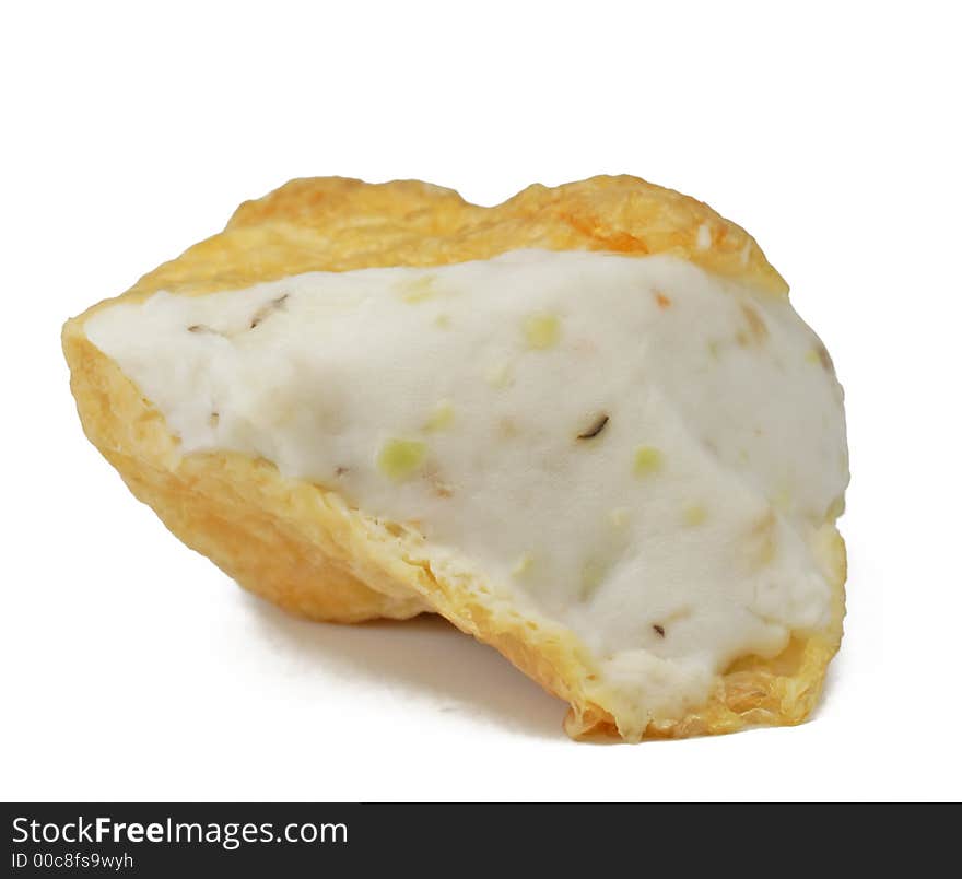 A piece of fried tofu isolated over white background