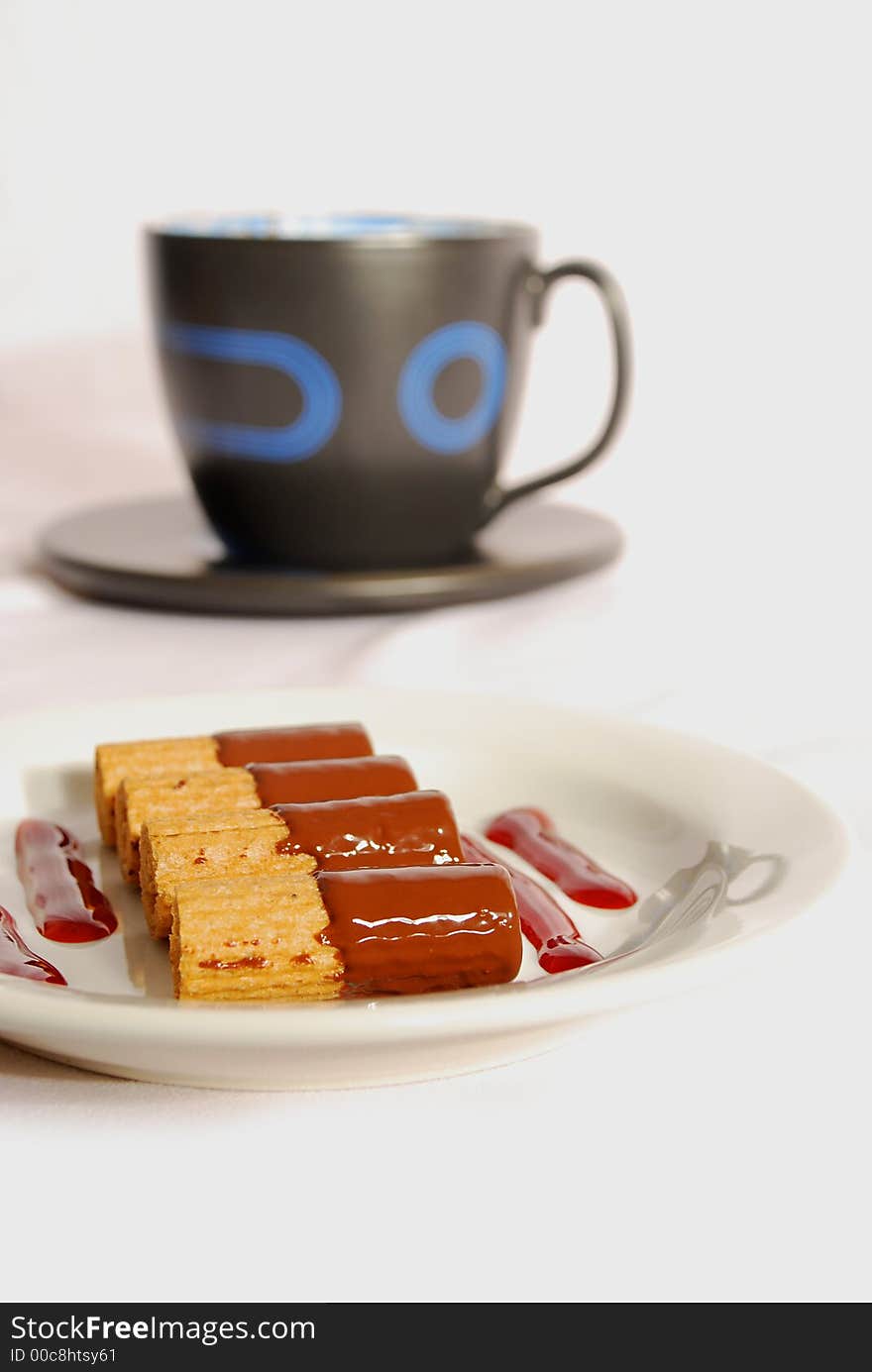 Black coffee cup with cookies over white background