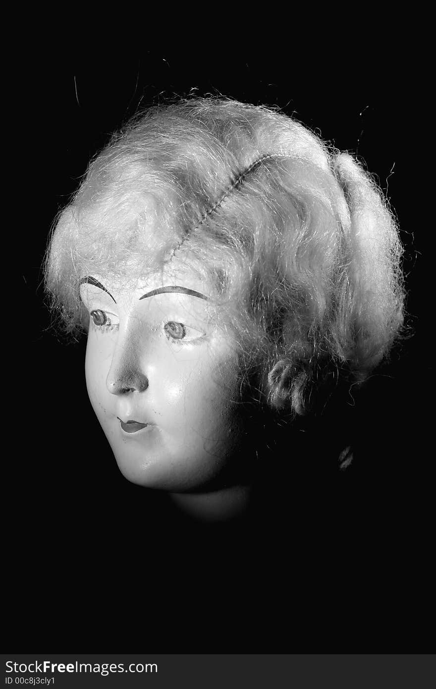 Picture of a old porcelain doll head.
Lighted with a spot light on black and white. Picture of a old porcelain doll head.
Lighted with a spot light on black and white