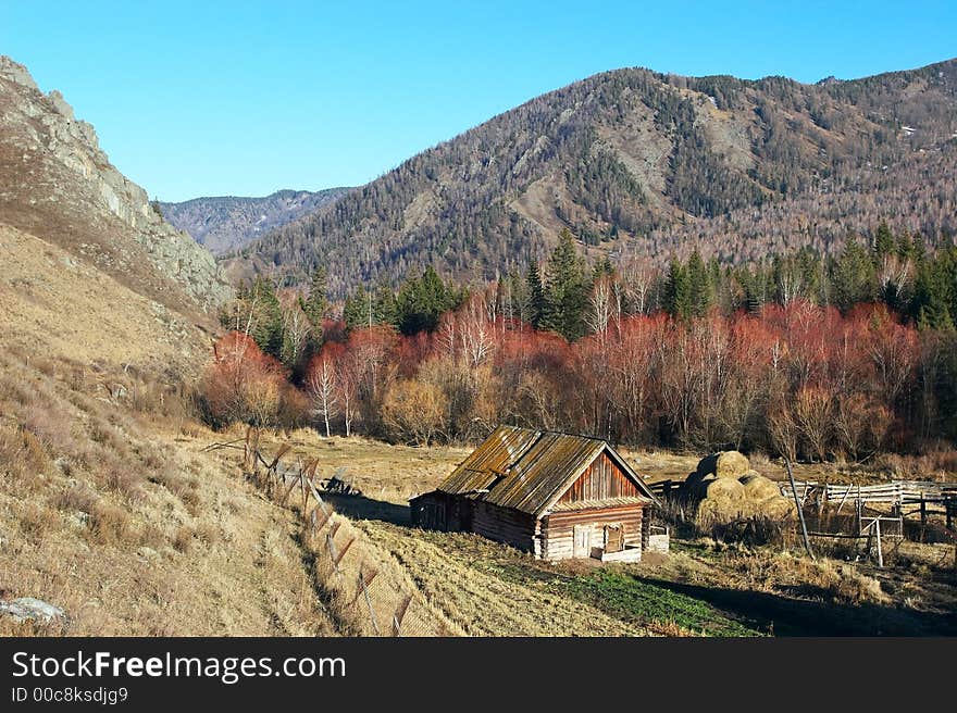 Old house, blue sky and mountains.