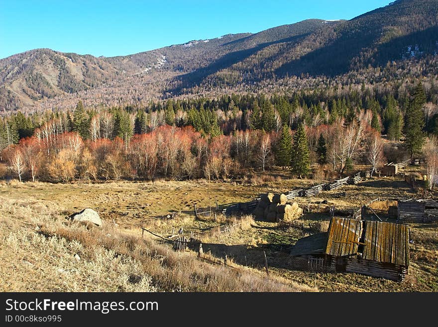 Old house, blue sky and mountains.