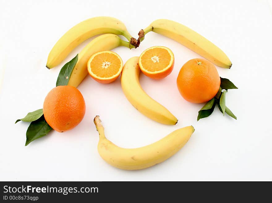 Fresh bananas and orange on white background (fruits, food, vitamin)