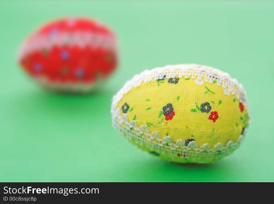 Two easter eggs on the green background - the symbol of spring