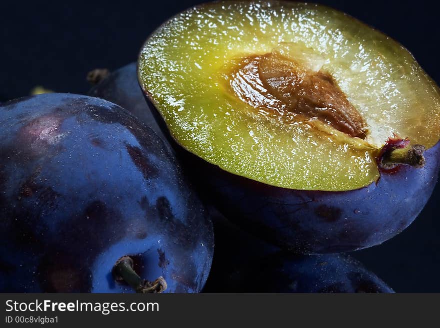 Dark blue ripe fleshy plums