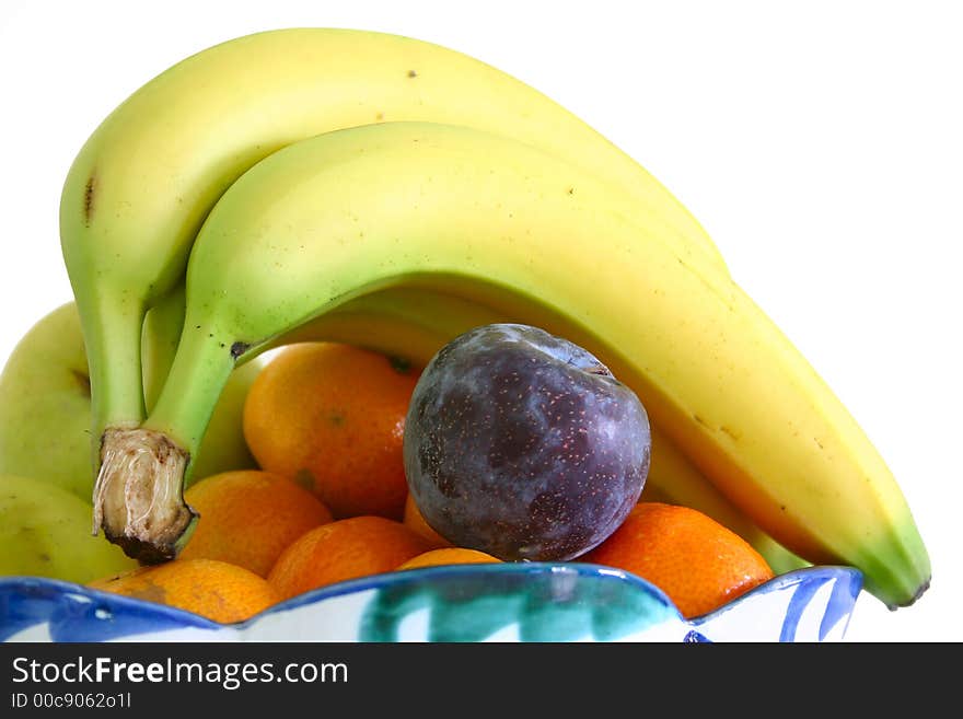 Bowl of fresh fruit isolated over a white background. Bowl of fresh fruit isolated over a white background