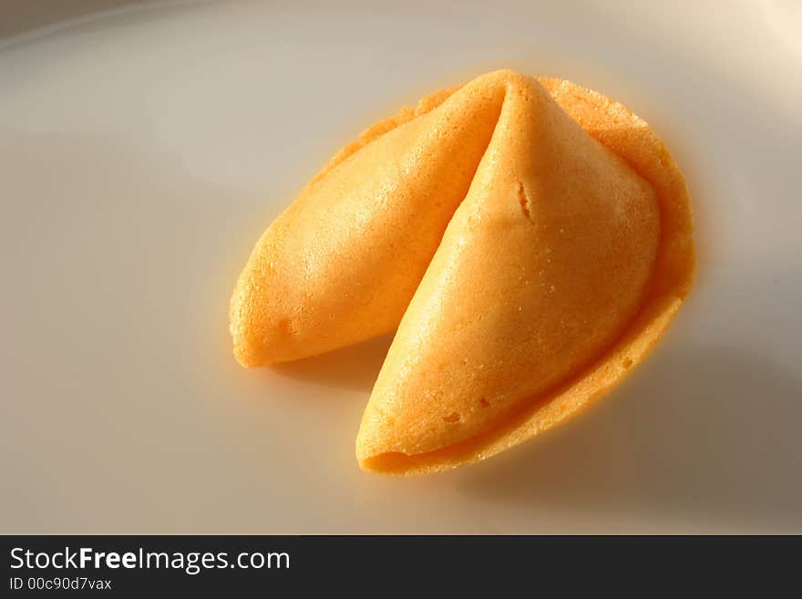 Open fortune cookie with the slip of paper sticking out