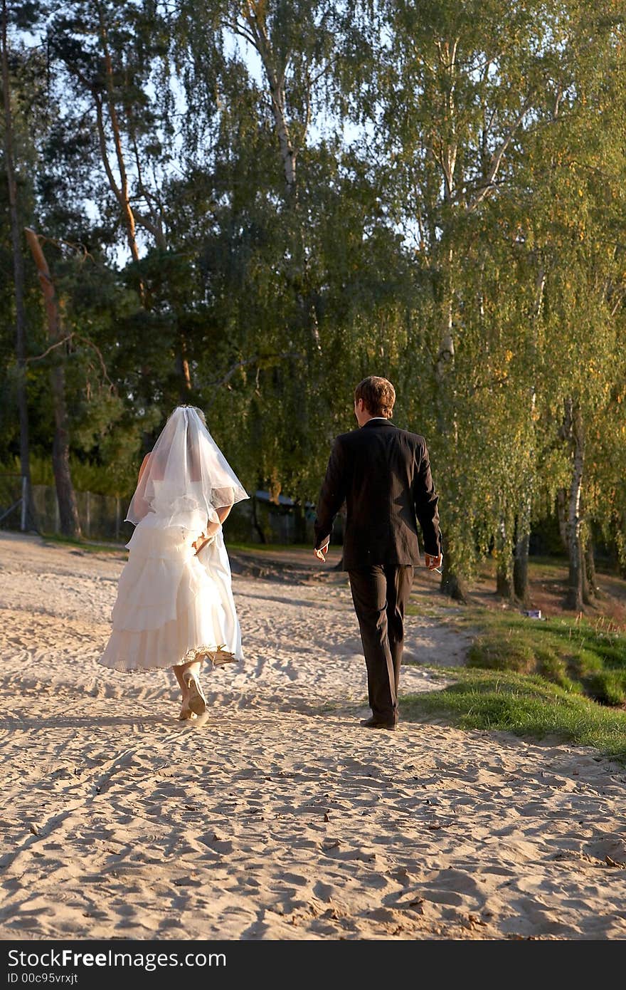 Man and woman are walking on beach. Man and woman are walking on beach