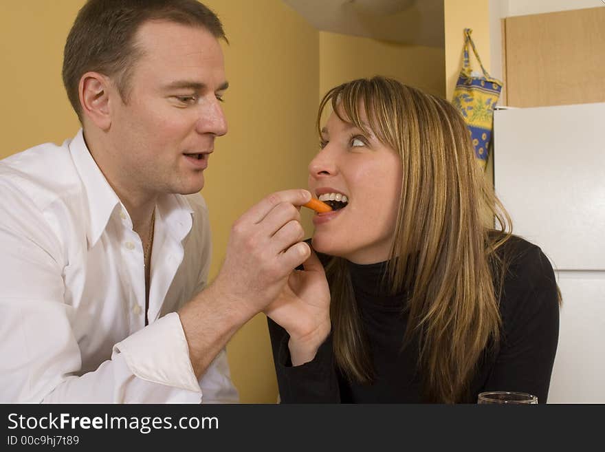 Happy couple cooking and kissing in the kitchen