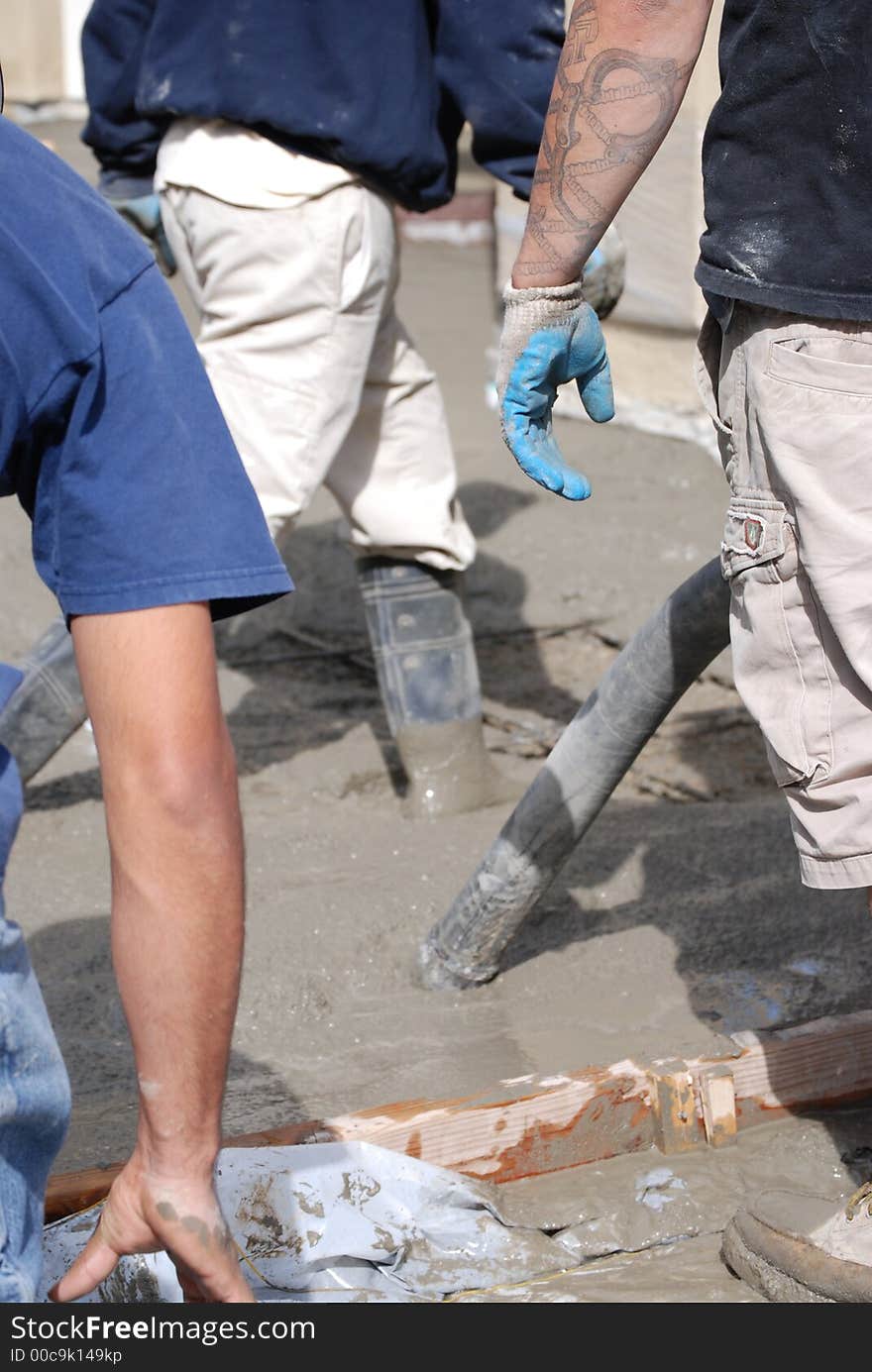 Men huslling around with boots in concrete. Men huslling around with boots in concrete