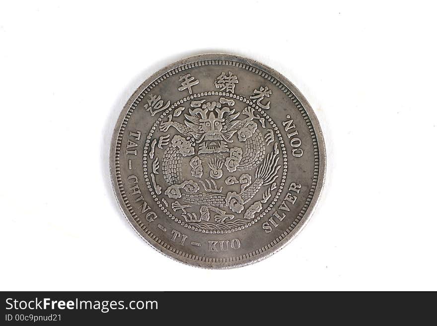 Old Chinese silver coin isolated over white. Old Chinese silver coin isolated over white.