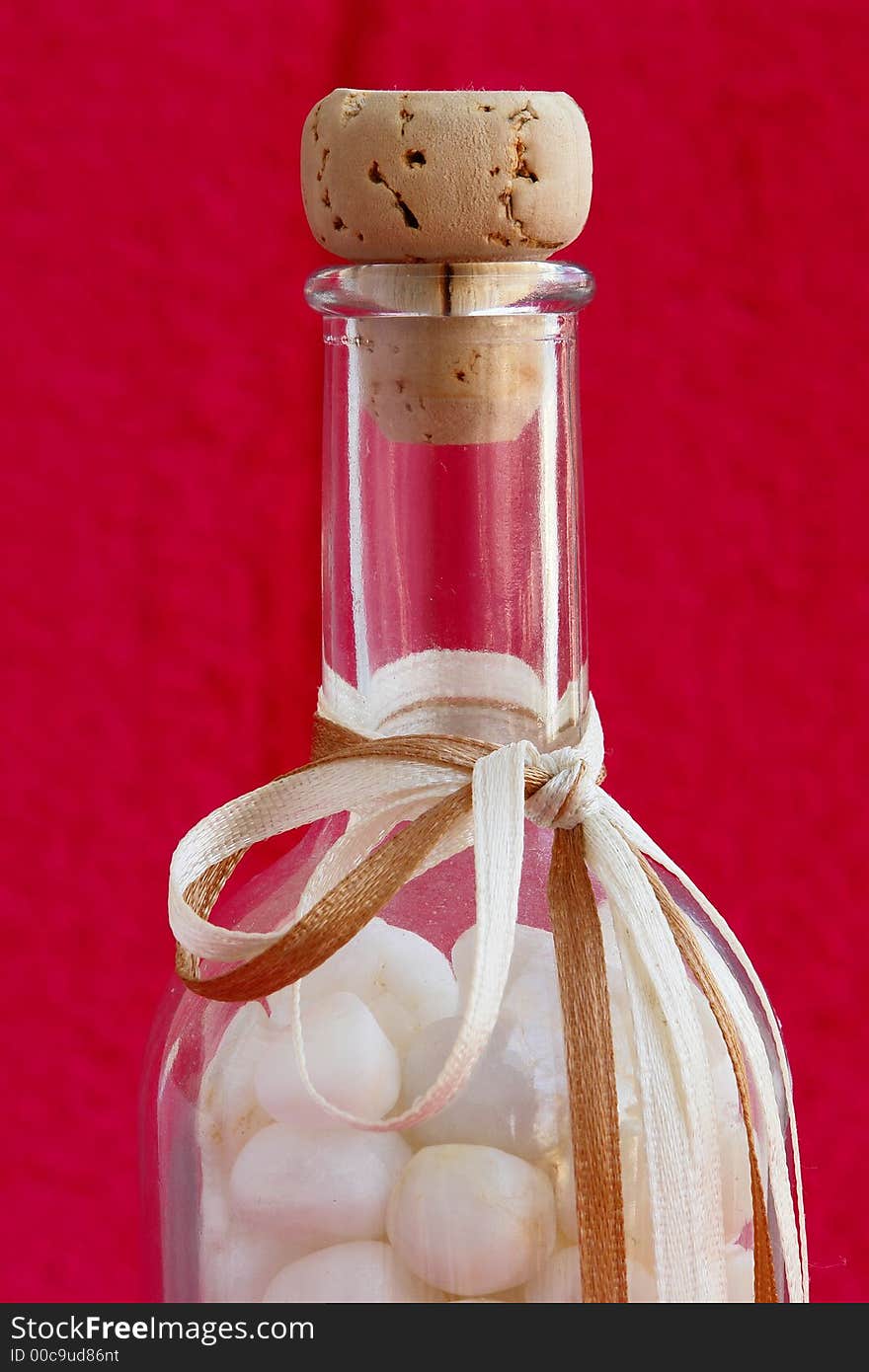 Bottle with small stones of marble from Thassos island, Greece