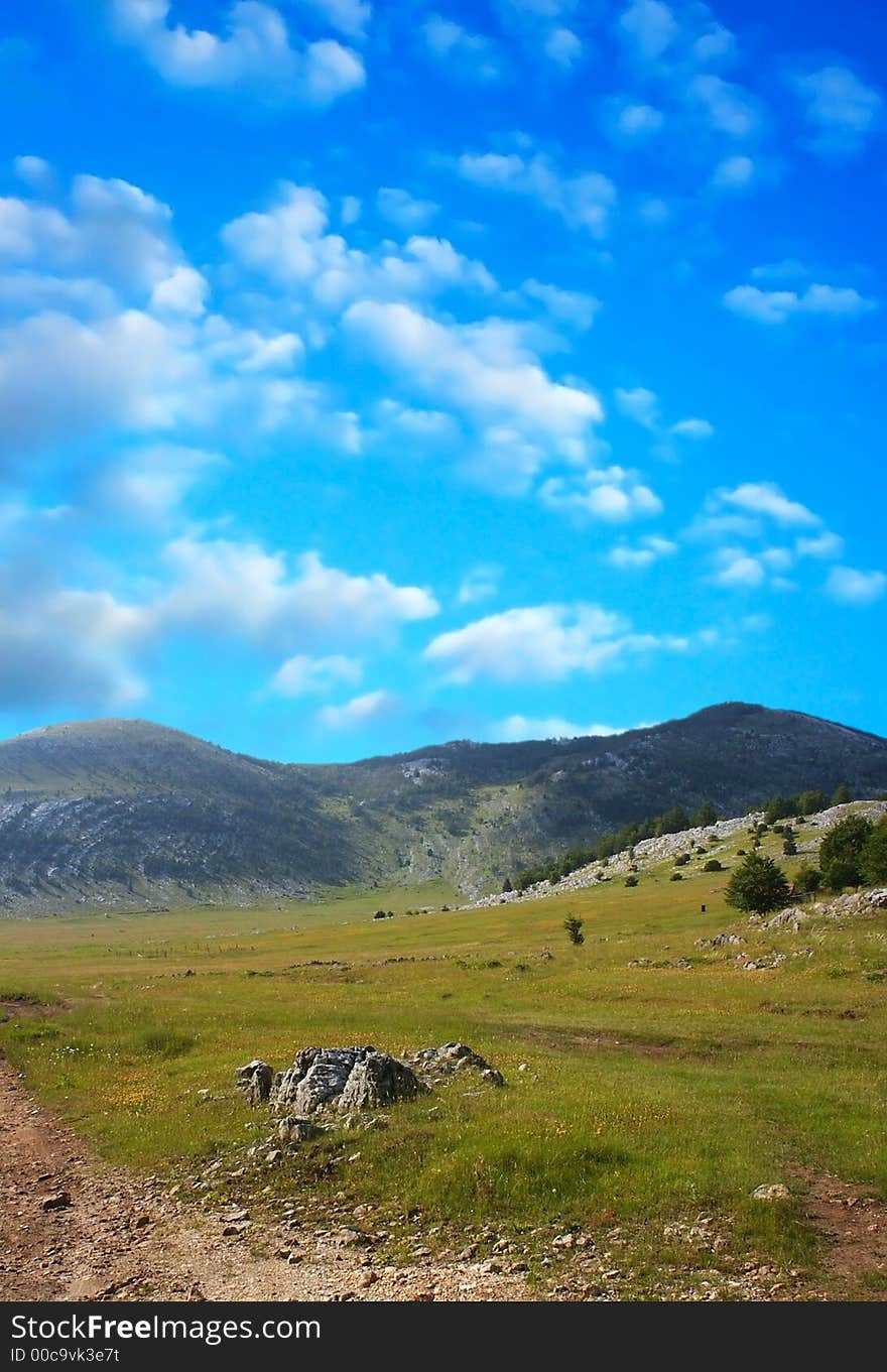 Dinara mountain over blue clouds 6