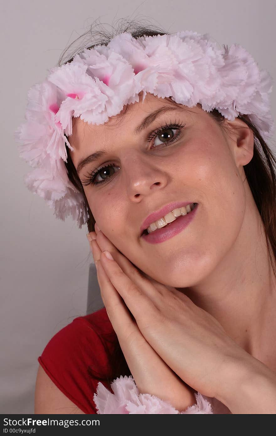 A beautiful hawaian looking girl smiles with flowers in her hair. A beautiful hawaian looking girl smiles with flowers in her hair.