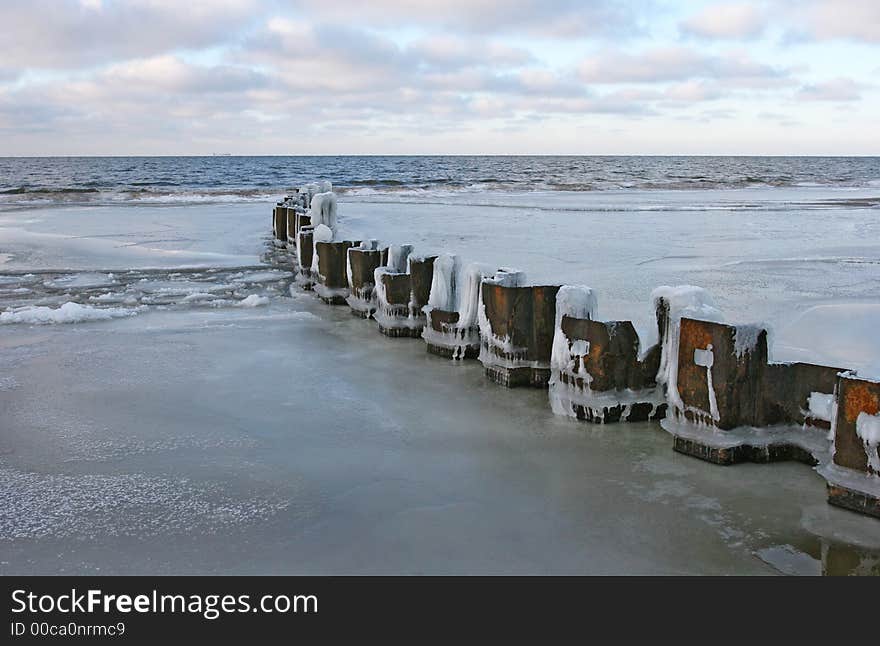 Demolished pier and ice on a Baltic sea coast (Latvia). Demolished pier and ice on a Baltic sea coast (Latvia)